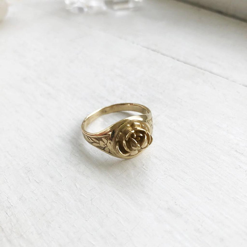 yellow brass rose signet ring with floral scrolls on side ring