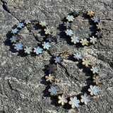 Floral-patterned bracelets on a textured stone surface