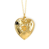 Gold heart-shaped pendant necklace with floral design on a white background