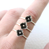 3 flower rings on finger