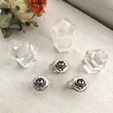 three rose signet rings displayed with three crystals