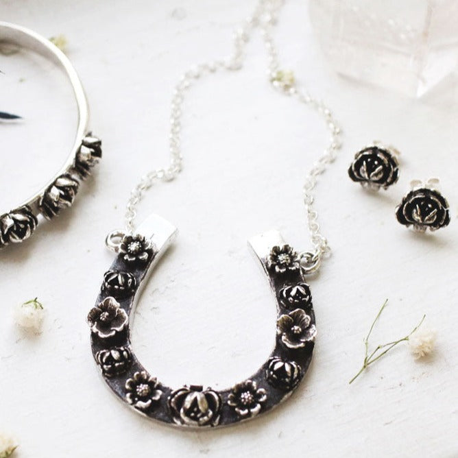 rose bracelet with large floral horseshoe pendant and rose stud earrings