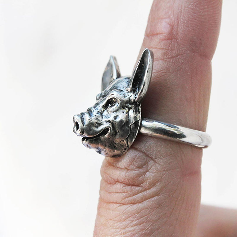 side view profile of a pig's face on a ring